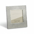 A pewter-colored metal picture frame with a geometric design around the photo window.