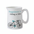 A white bone china small jug with turquoise text and a black graphic of a bicycle, alongside the phrase 'Happiness is riding a bike'.